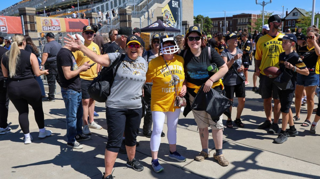 Fans pose for a photo at the Labour Day Classic Game in 2025. 